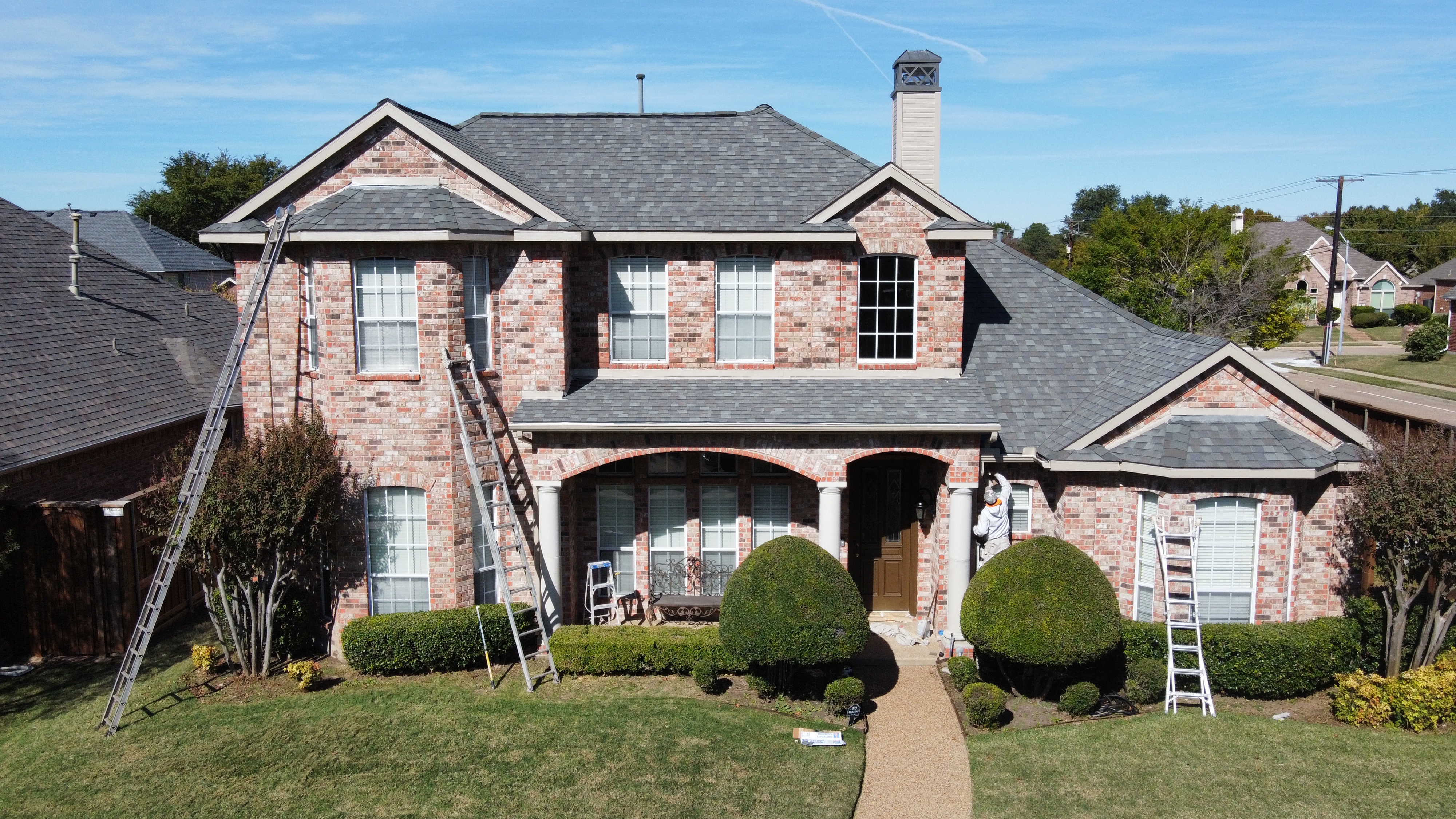 Freshly painted brick house with classic red finish